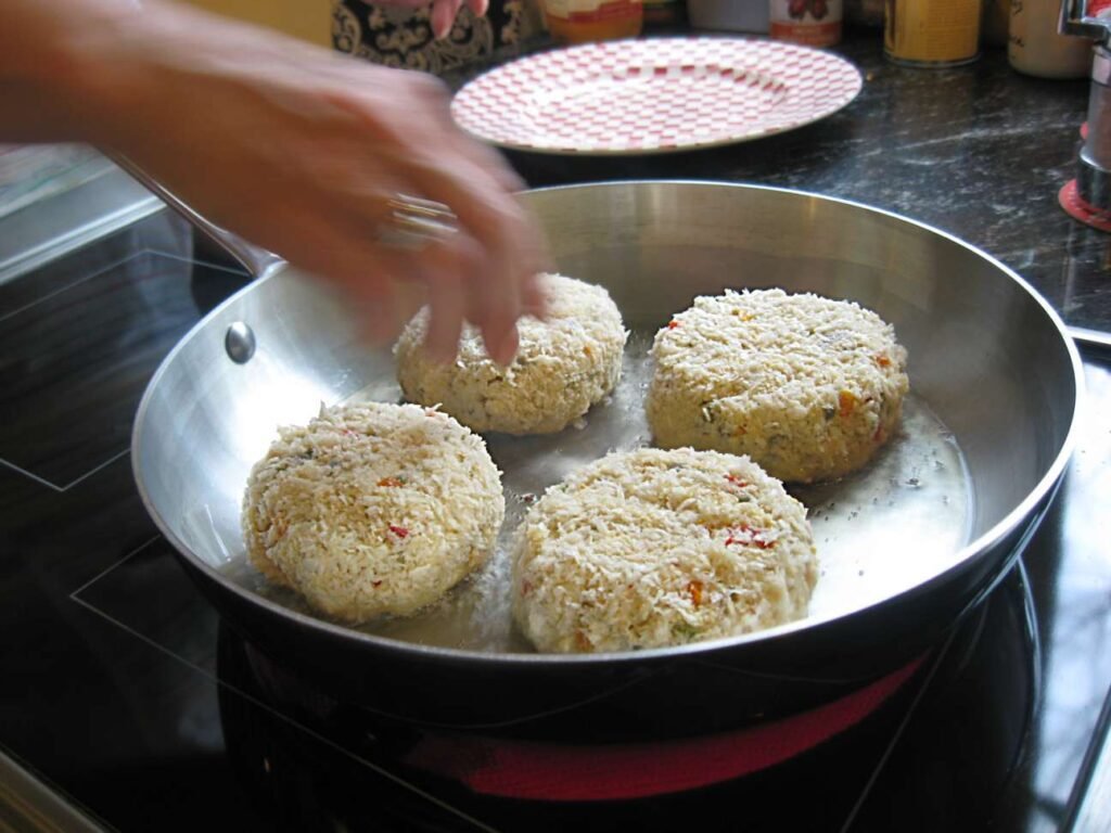 Large frying pan with crab cakes