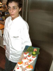 Chef Vanda crafting dishes behind the kitchen line